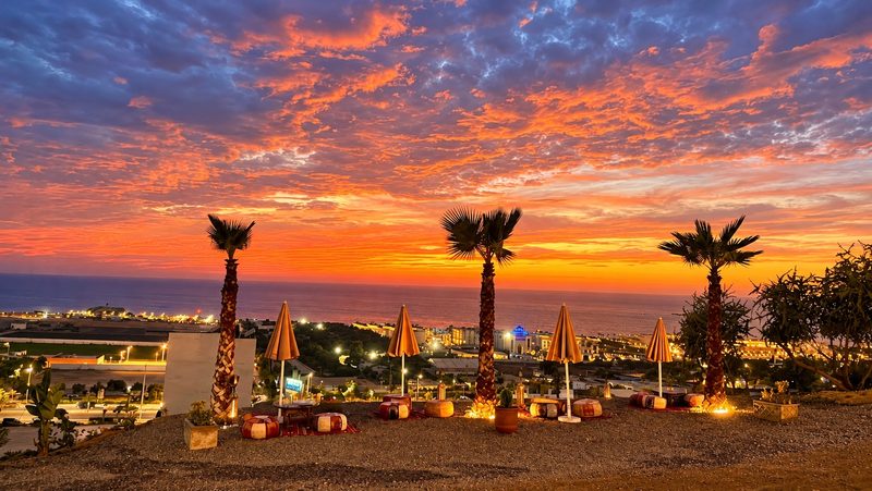 The terrace of L’Endroit at sunset, facing the ocean in Tamraght